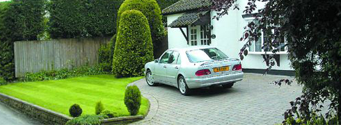 Car parked on a grey driveway